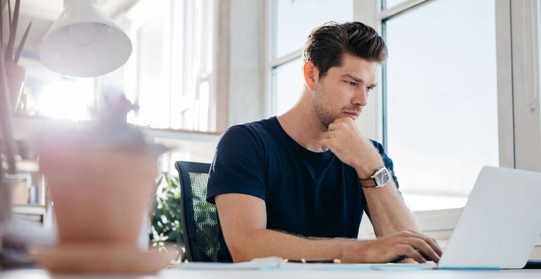 Handsome young man using laptop